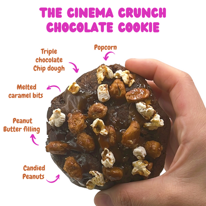 Indulge in The Cinema Crunch Chocolate Cookie from The Dough Corner – a delicious combination of quadruple chocolate chip dough, creamy peanut butter filling, caramel bits, and candied peanuts. Ideal for satisfying chocolate cravings.