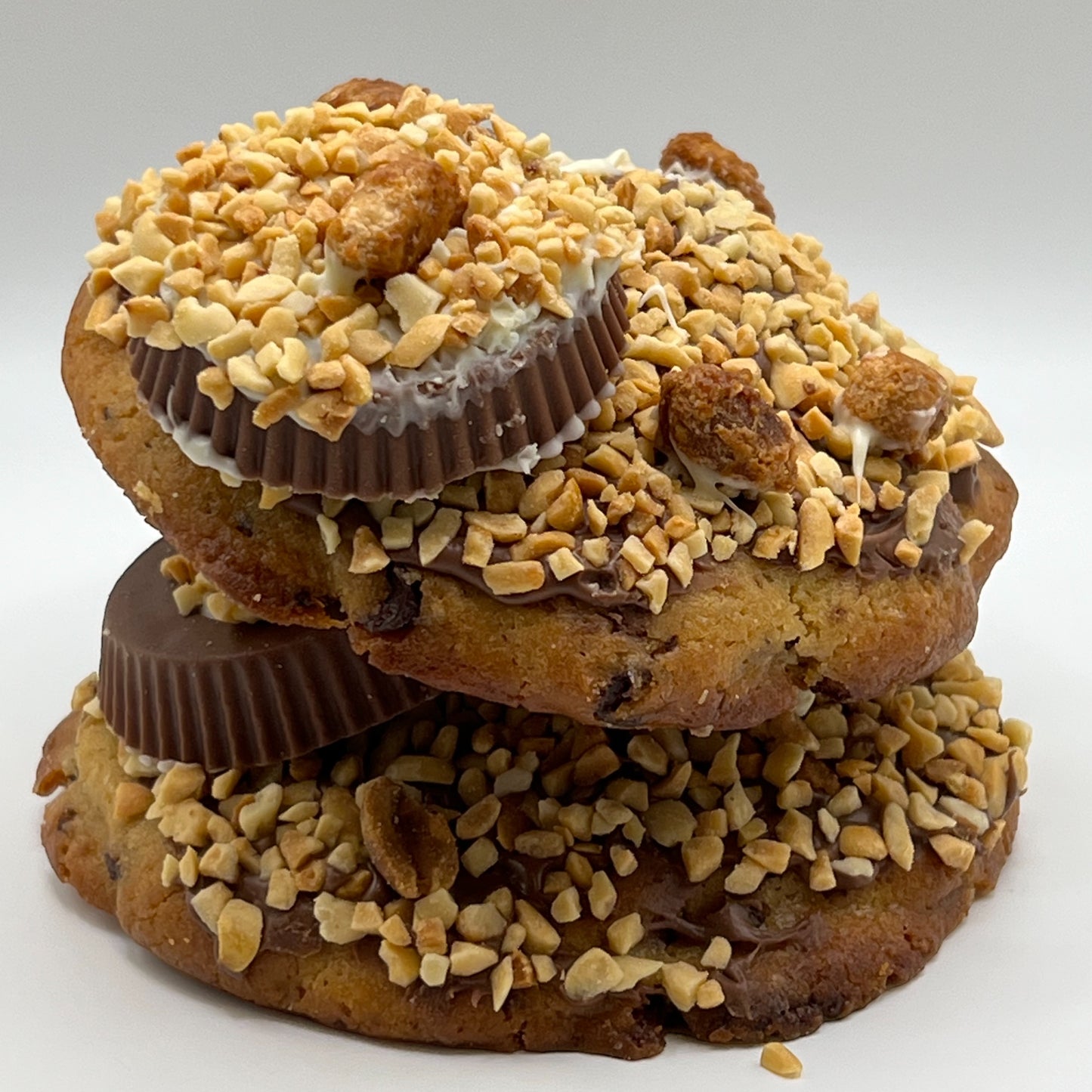 Close-up of The Peanut Cup Chocolate Chip Cookie with visible chocolate chips and peanut butter cup. 